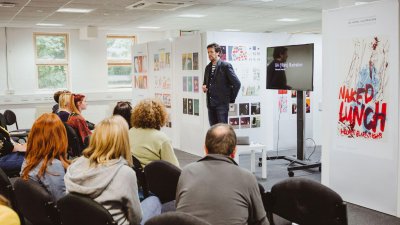 Falmouth University Illustration lecturer talking to group of prospective students and parents.