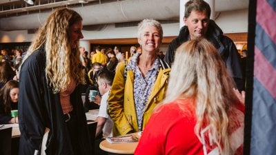 Parents smiling with daughter at an Open Day at Falmouth University