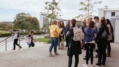 Student ambassador talking to a group of prospective students and their parents on an open day