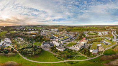 A wide angle aerial shot of Penryn campus with buildings and fields.