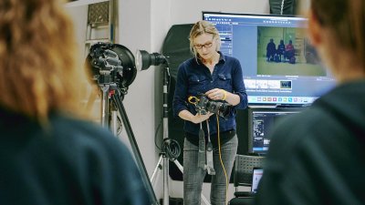 Falmouth Photography lecturer using camera equipment in a studio