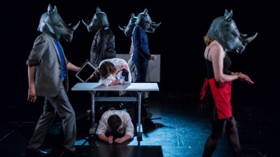 Actors with Rhinoceros masks on stage at AMATA