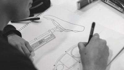 Student drawing design for a bike seat.