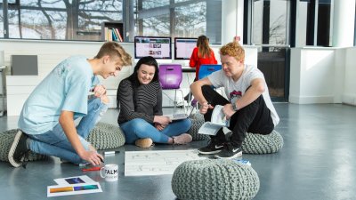Falmouth University Business students sat on pebble cushions discussing ideas.