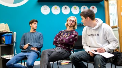 Students sat on chairs and having a discussion.