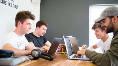 Business students working on laptops