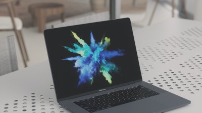 Laptop with a burst of powdered colours.