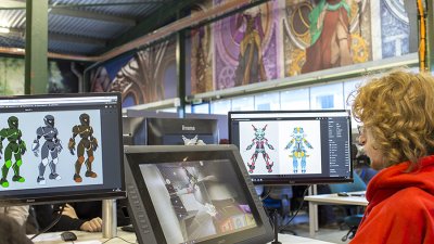 Student sat in front of screens in the Games Academy