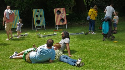Families playing games in the gardens on Falmouth Campus
