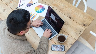 Person sat at a desk working on a laptop