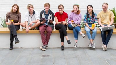 Students sitting on a wall