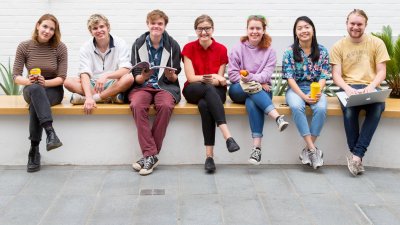Students sitting on a wall