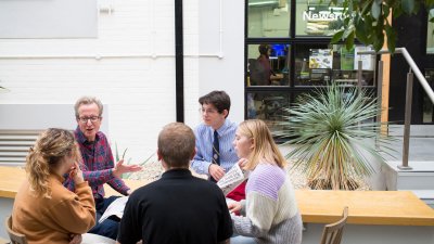 Journalism students sitting in a circle