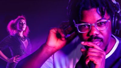 Photo of students Ephraim and Flo on blue and purple smoky background.