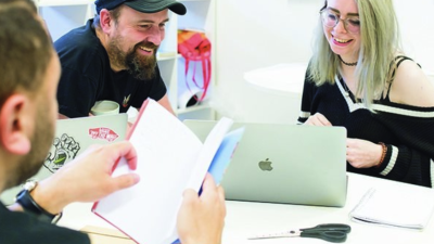 Creative advertising students discussing work