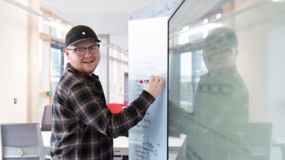 Falmouth University Sustainable Business student writing on a white board
