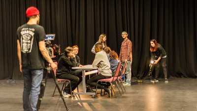 Photo of actors in rehearsal on a stage