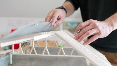 Hands holding an architectural model