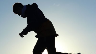 A silhouette of a person running outdoors