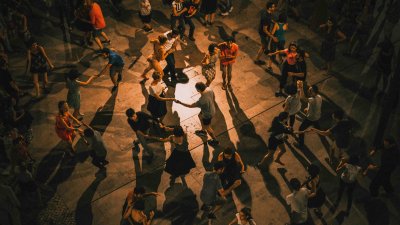 A cuban salsa dance class shown from above with lots of people dancing