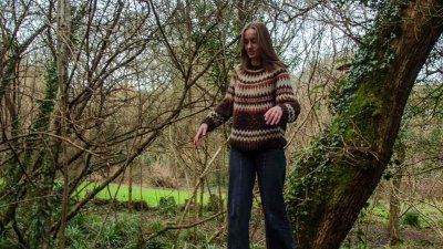 Emily Collis, Musician, standing in a woodland scene