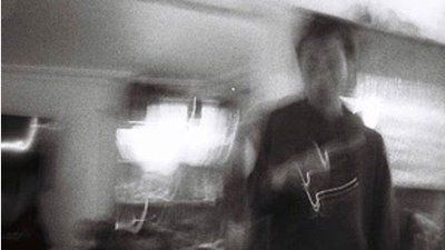 A black and white blurred image of Joe Nichols