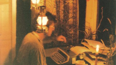 An image of Nick Darke writing at a desk