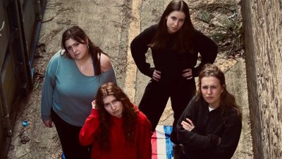 A group of 4 people with the Union Jack flag under them
