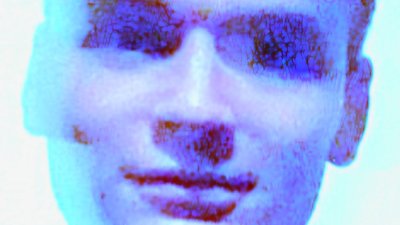 A blurred headshot of Toby Alford
