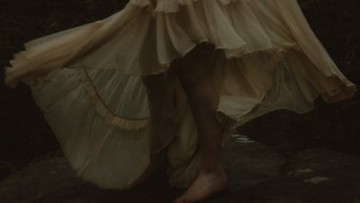 A woman's feet standing on a rock