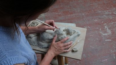Emily Roberts making a reclining figure sculpture