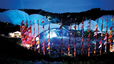 Landscape view of the Eden project lit up at an evening event