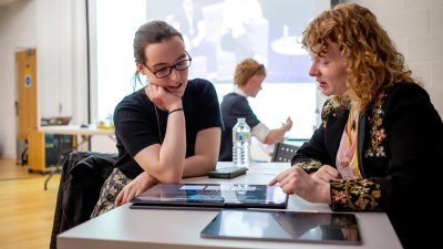 A student and industry person discussing work on a screen