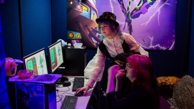Two Falmouth University students playing a game at the Games Expo