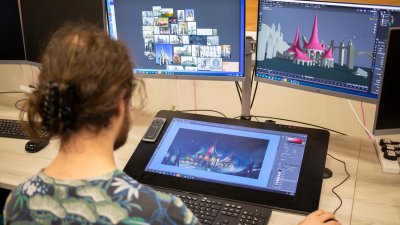 A man working on a game design of a castle