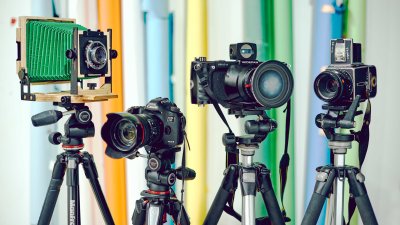 Set of 4 different types of cameras on tripods