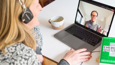 Adult learner taking part in an online seminar on their laptop 