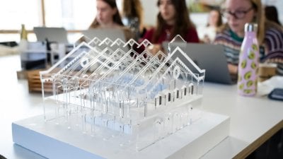 Clear plastic model of a building with a pitched roof