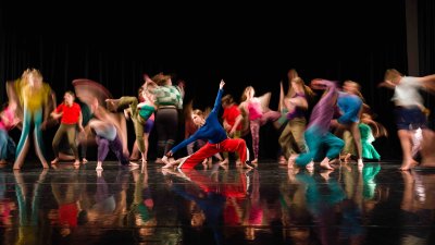 Group of dancers in brightly coloured clothes