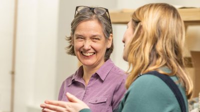 Two women at Falmouth University talking and smiling