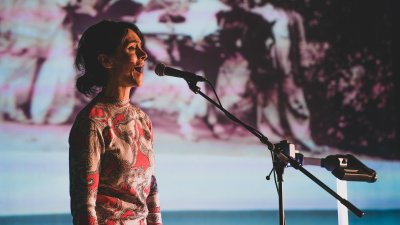 A woman singing into a microphone