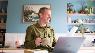 Man sitting at a desk working on his laptop