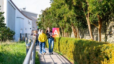 A group of people walking outside at a Falmouth University Open Day