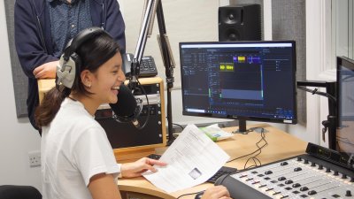 A female student working in an radio studio at Falmouth University