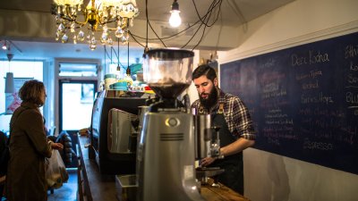 Man working behind the counter at a coffee shop