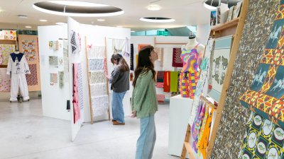 Two women looking at Textile Design student work at Falmouth University