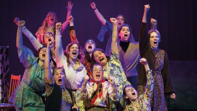 Group of female actors shouting with arms in the air