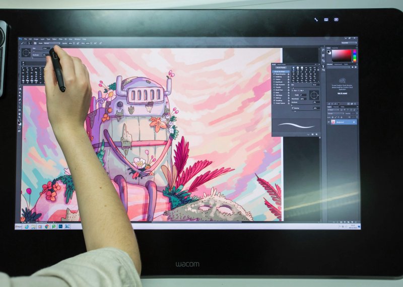 Animation student drawing a robot on a graphic tablet
