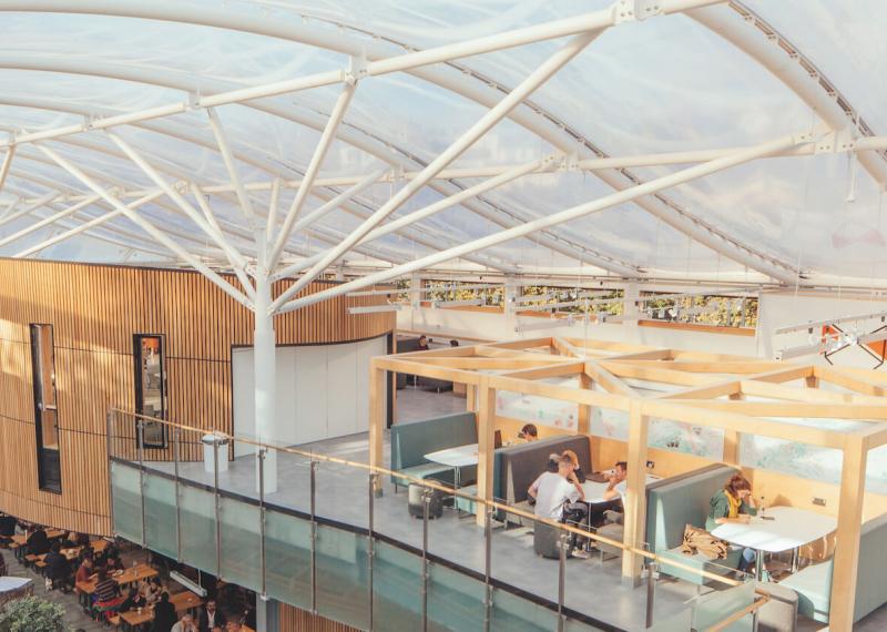 Students working at the Atrium on Falmouth University campus.