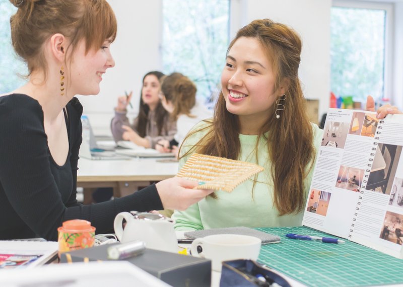 Two Interior Design students at a desk